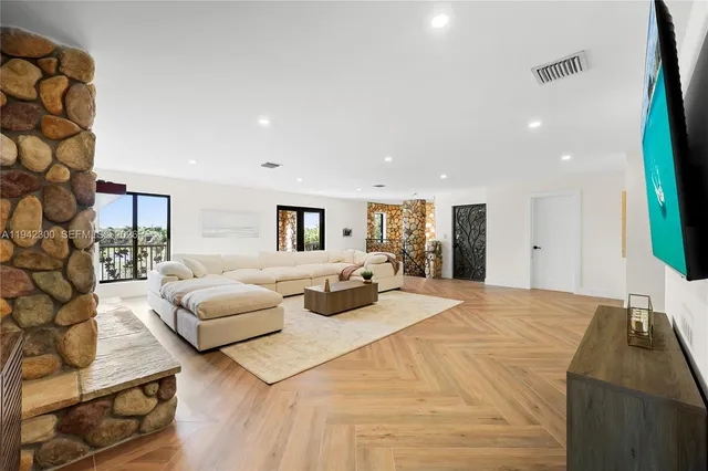 an aerial view of a house with a garden and lake view