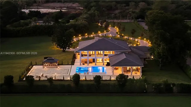 a view of a house with backyard and sitting area