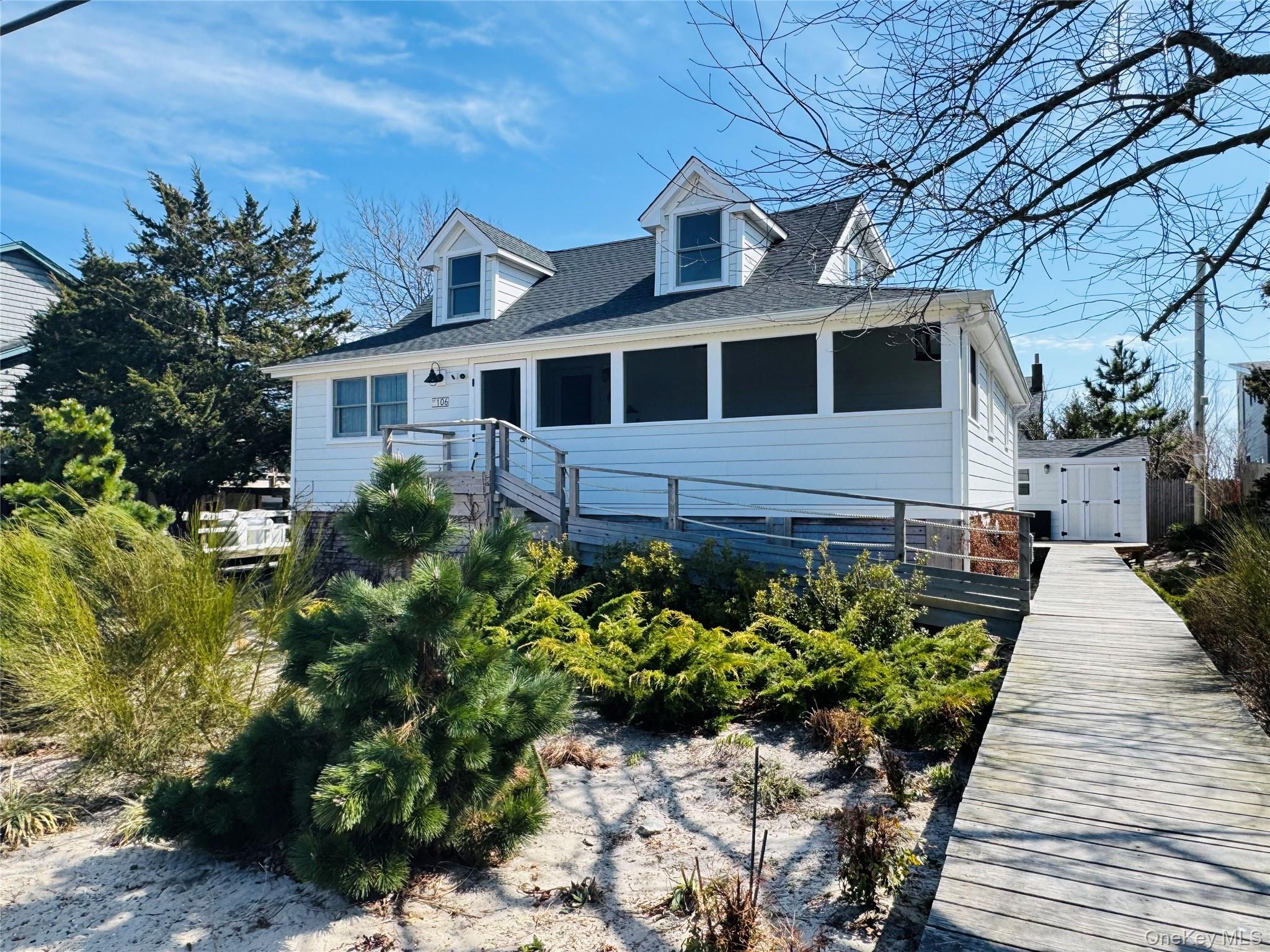 106 Oak Beach Road Babylon, NY 11702 - Photo 1 of 34 a front view of a house with a yard