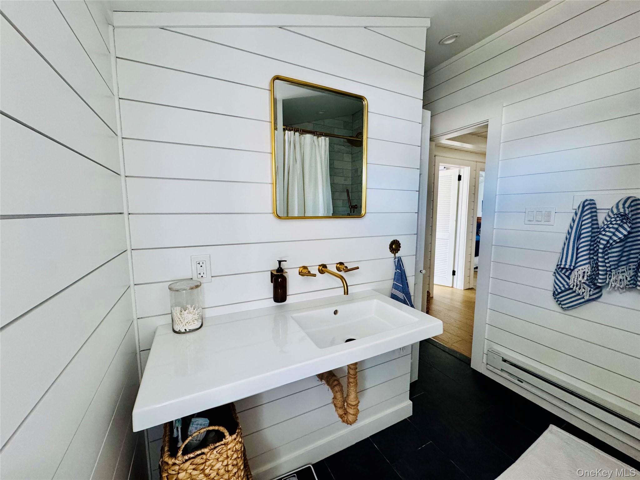 106 Oak Beach Road Babylon, NY 11702 - Photo 12 of 34 a bathroom with a sink and a mirror