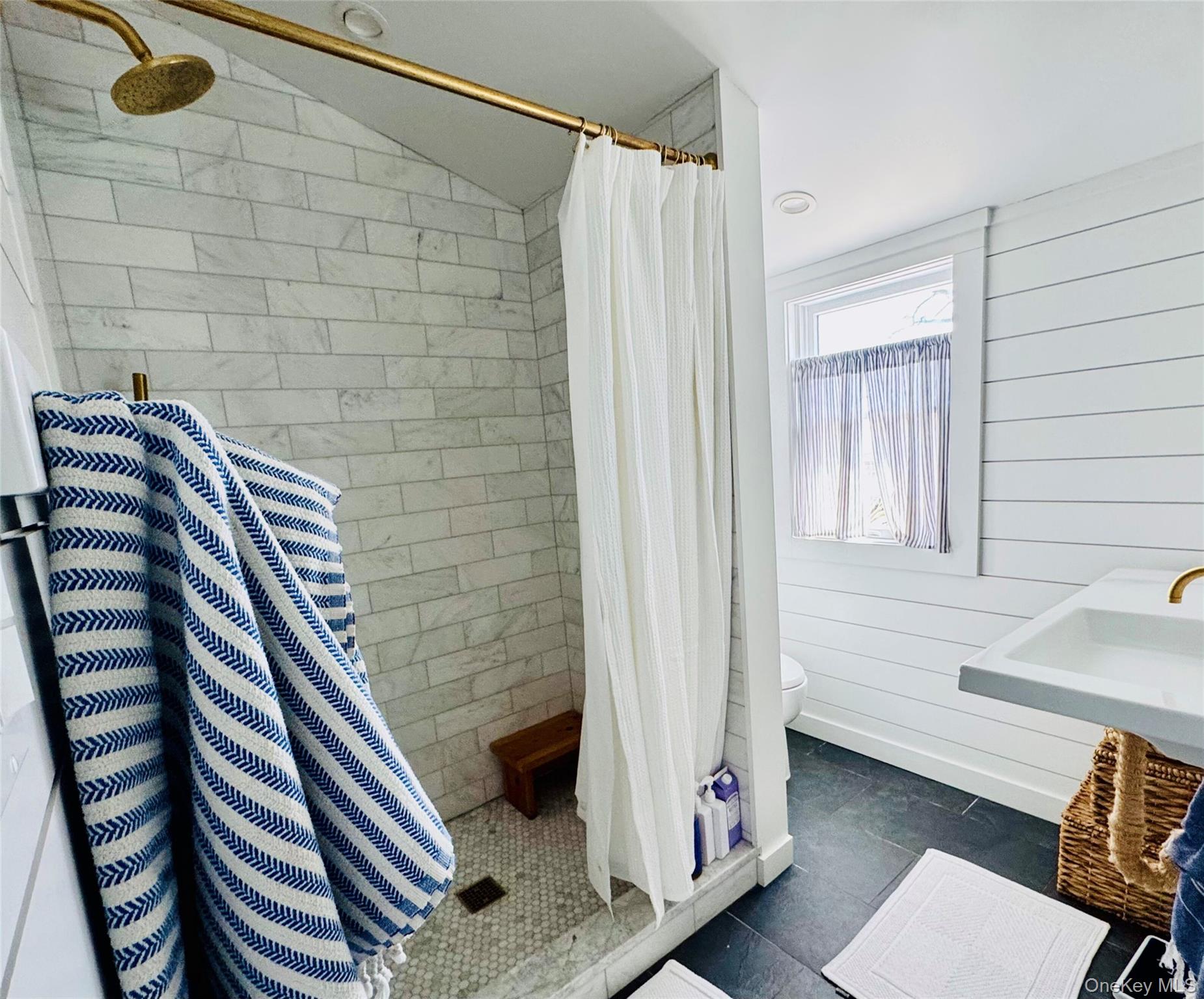 106 Oak Beach Road Babylon, NY 11702 - Photo 13 of 34 a bathroom with a shower and a sink
