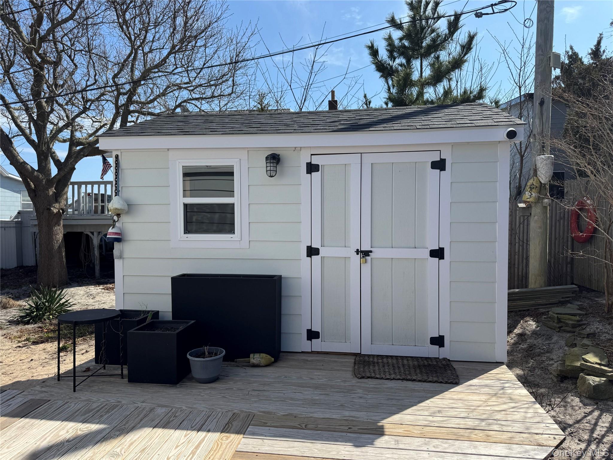 106 Oak Beach Road Babylon, NY 11702 - Photo 19 of 34 a outdoor space with patio furniture and a fireplace
