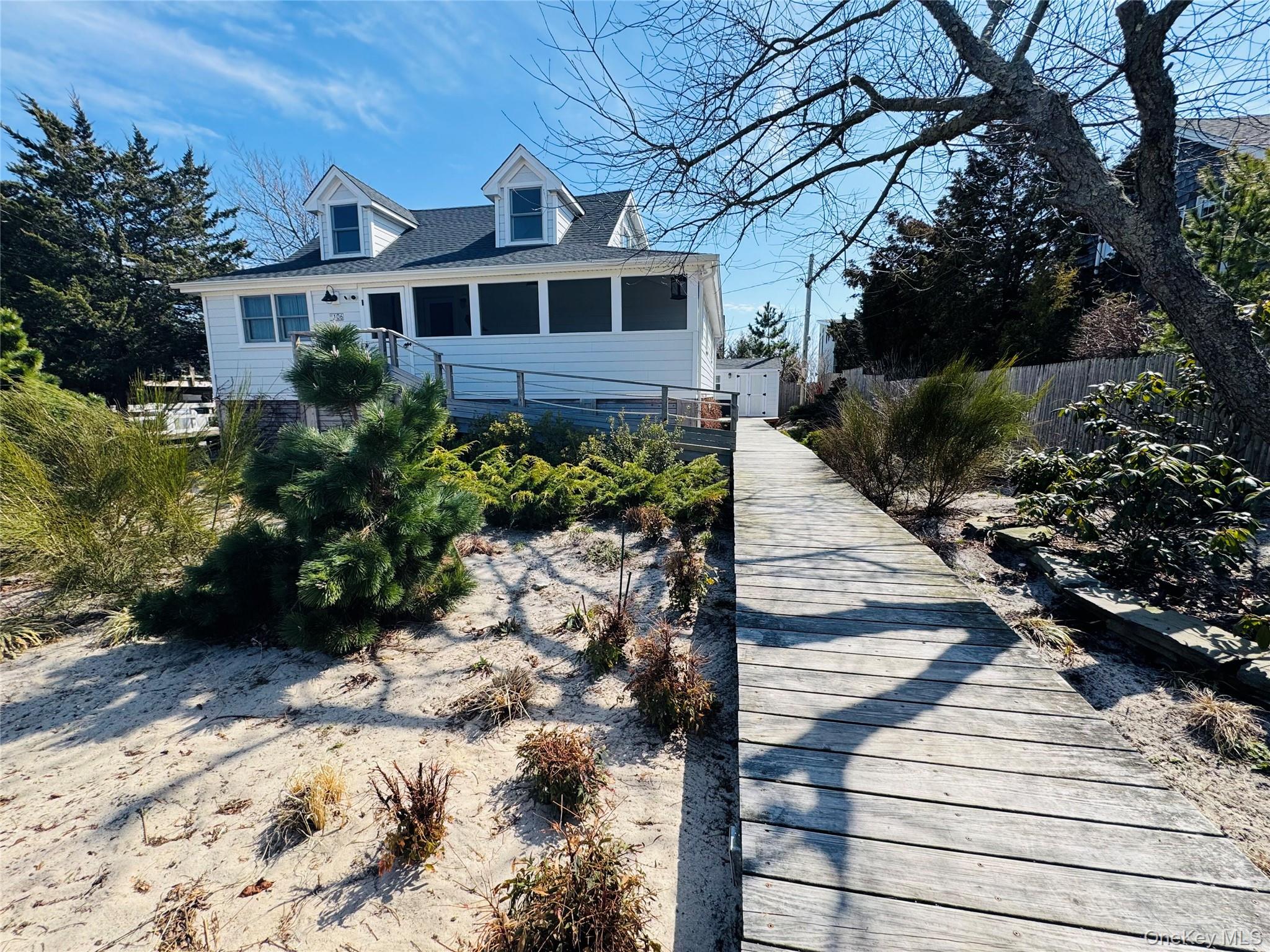 106 Oak Beach Road Babylon, NY 11702 - Photo 20 of 34 a front view of a house with a yard