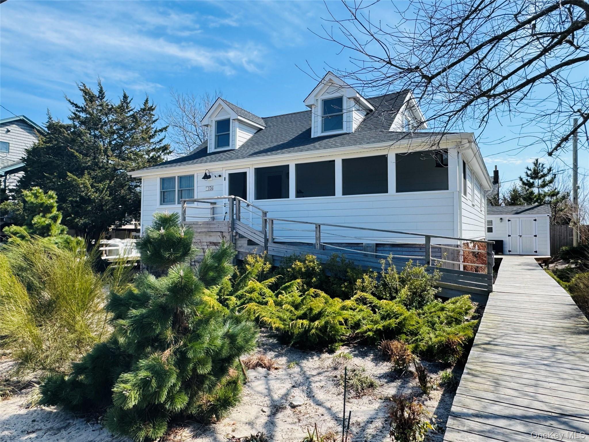 106 Oak Beach Road Babylon, NY 11702 - Photo 26 of 34 a front view of a house with a yard