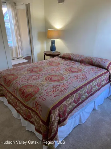 a bed sitting in a bedroom next to a window