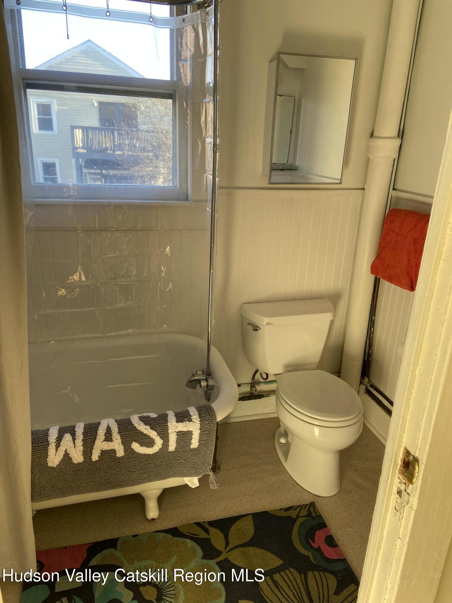 251 Robinson Street, Unit 2 Hudson, NY 12534 - Photo 7 of 7 a bathroom with a toilet and a shower