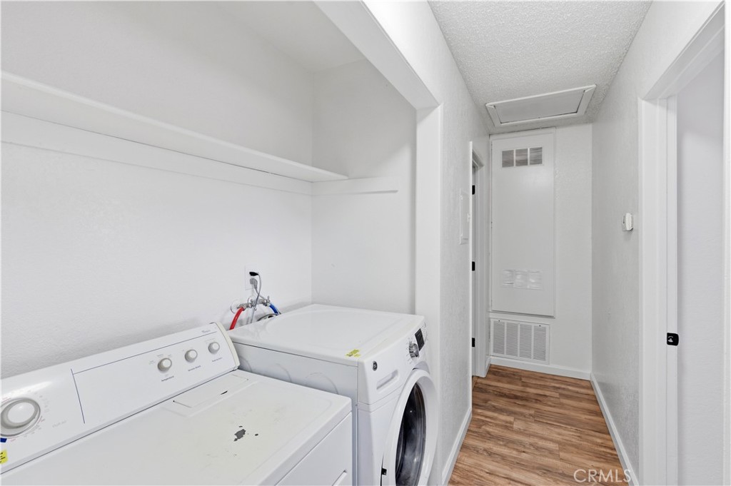 21739 Panoche Road Apple Valley, CA 92308 - Photo 12 of 49 a view of washer and dryer with bathroom in the background