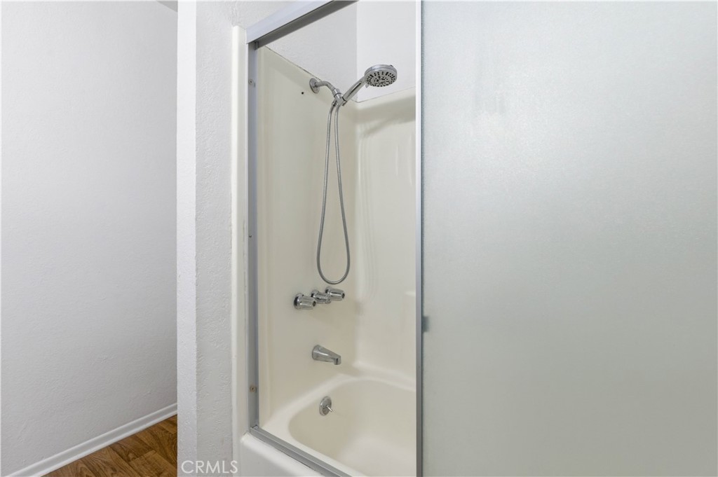 21739 Panoche Road Apple Valley, CA 92308 - Photo 17 of 49 a bathroom with a glass shower door