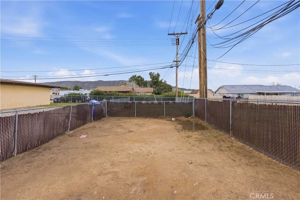 21739 Panoche Road Apple Valley, CA 92308 - Photo 18 of 49 a view of a terrace with wooden fence