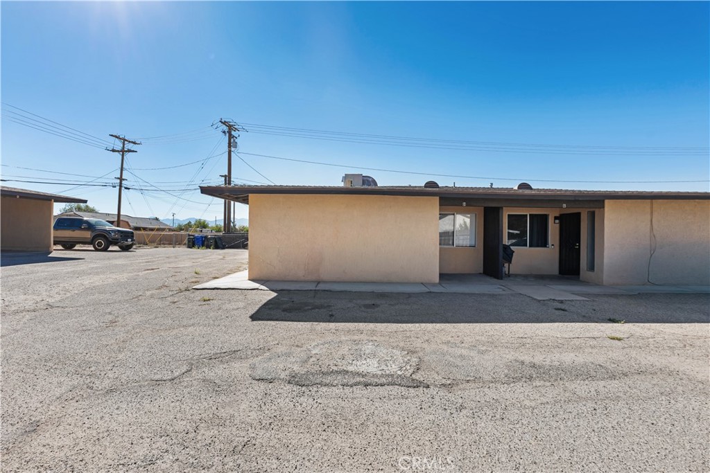 21739 Panoche Road Apple Valley, CA 92308 - Photo 22 of 49 a front view of a house with a yard