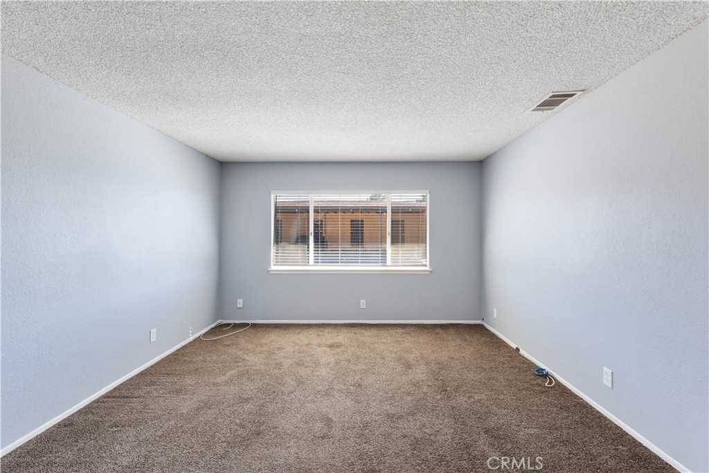 21739 Panoche Road Apple Valley, CA 92308 - Photo 24 of 49 an empty room with a window