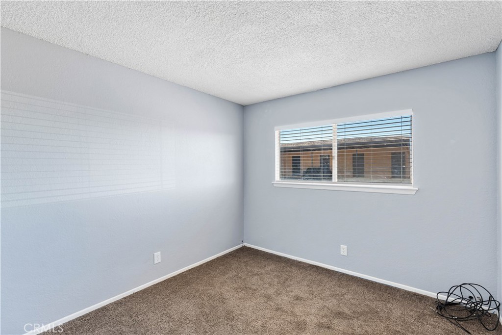 21739 Panoche Road Apple Valley, CA 92308 - Photo 31 of 49 a view of an empty room with a window