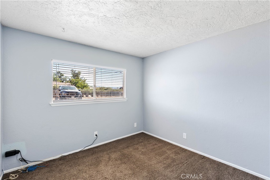 21739 Panoche Road Apple Valley, CA 92308 - Photo 33 of 49 an empty room with a window