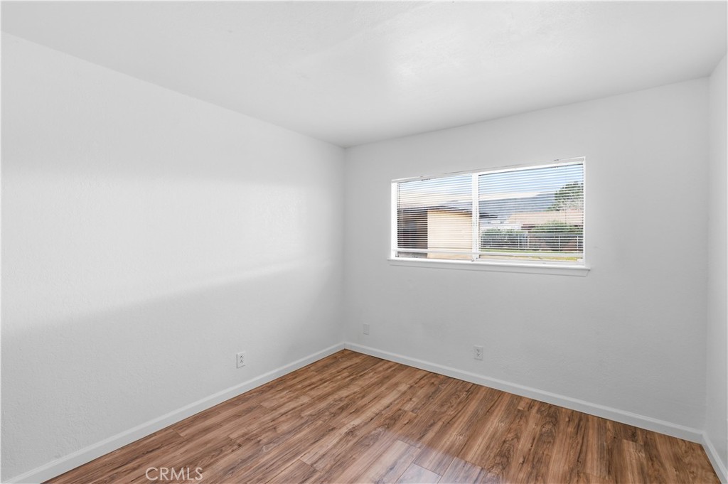 21739 Panoche Road Apple Valley, CA 92308 - Photo 4 of 49 a view of empty room with wooden floor and fan