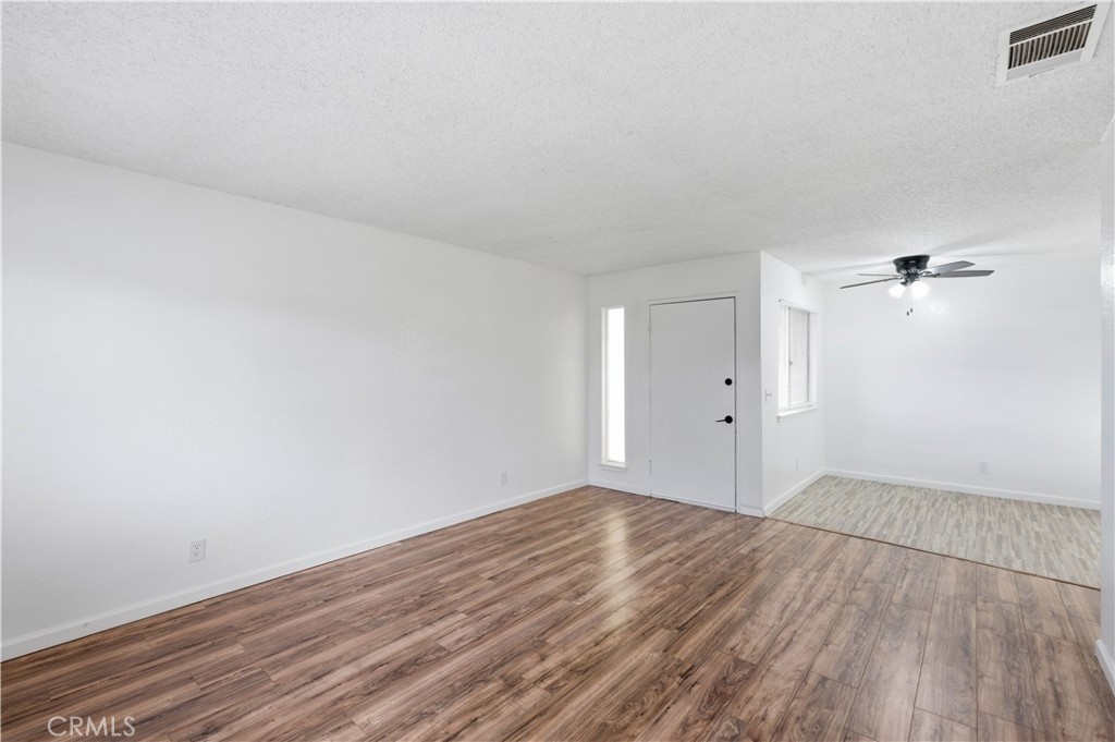 21739 Panoche Road Apple Valley, CA 92308 - Photo 5 of 49 an empty room with wooden floor