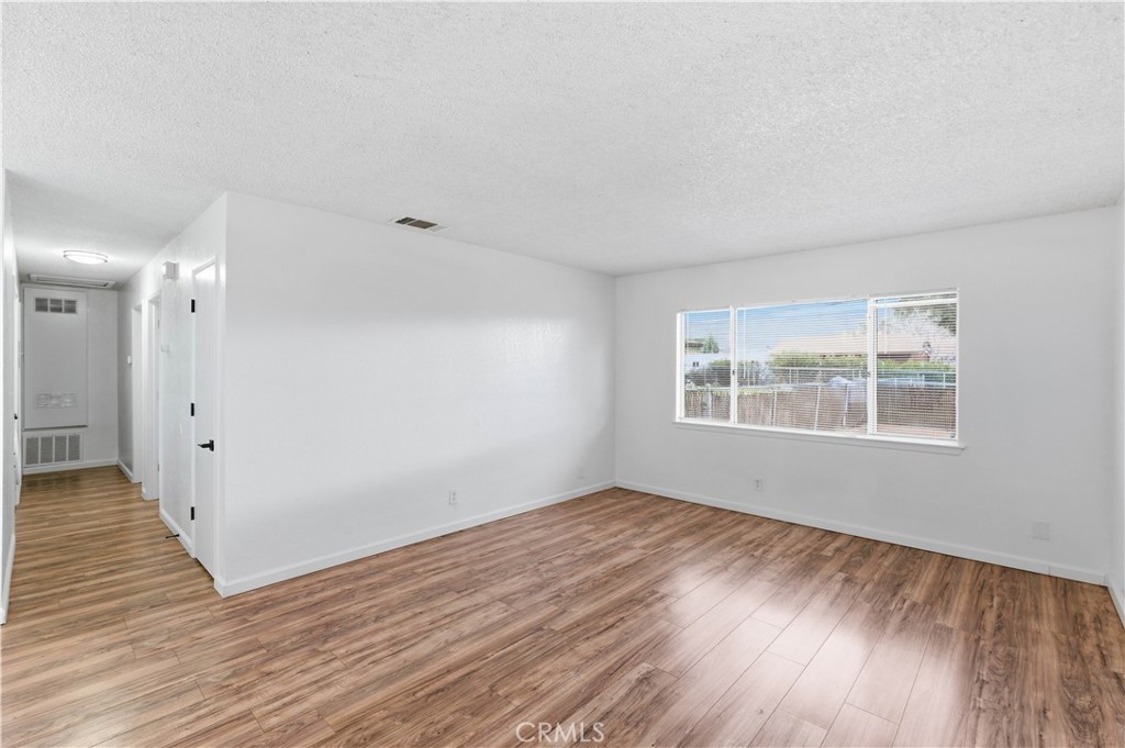 21739 Panoche Road Apple Valley, CA 92308 - Photo 6 of 49 wooden floor in an empty room with a window
