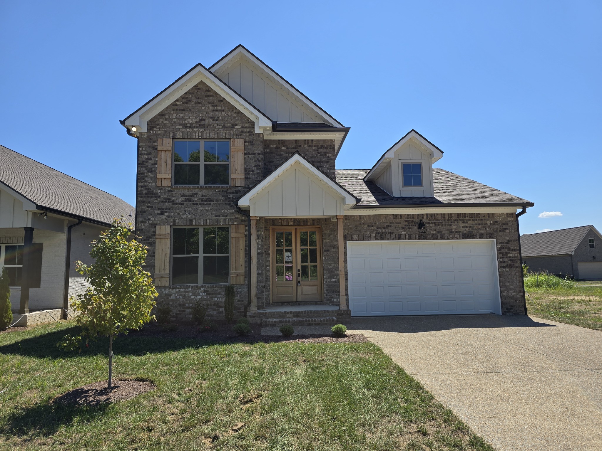 a front view of a house with a yard and garage