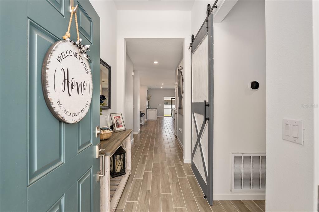5688 Southwest 92nd Place Ocala, FL 34476 - Photo 6 of 54 a view of a hallway with wooden floor