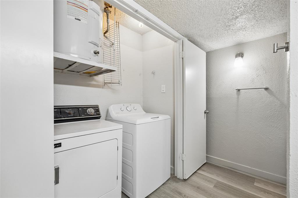 11480 Audelia Road, Unit 136 Dallas, TX 75243 - Photo 29 of 29 Dedicated utility area featuring wood-finish flooring, white textured walls, and overhead lighting