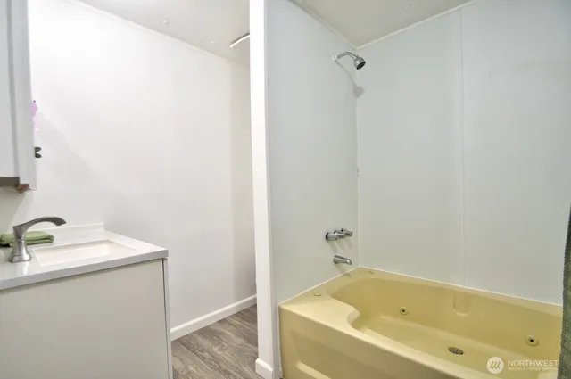 a bathroom with a tub and a sink