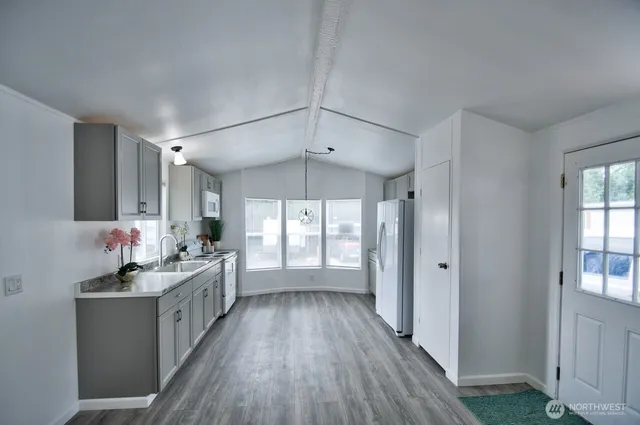 a bathroom with a double vanity sink a mirror and a bathtub