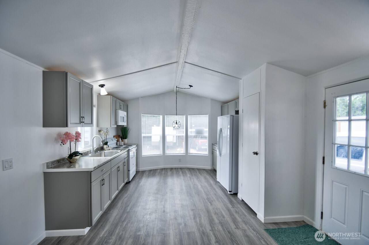 2115 Rocky Point Road Northwest, Unit 22 Bremerton, WA 98312 - Photo 4 of 16 a bathroom with a double vanity sink a mirror and a bathtub