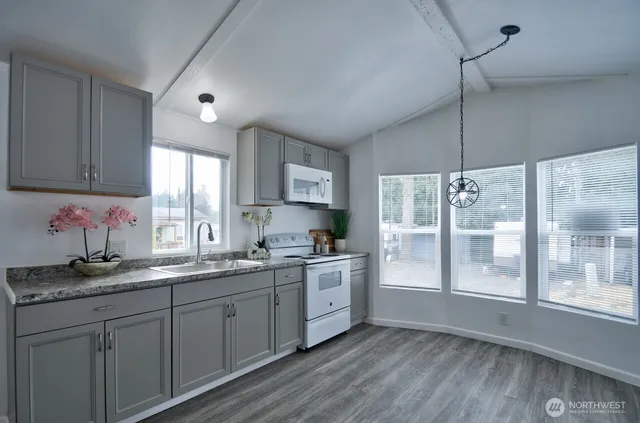 a kitchen with a sink cabinets and window