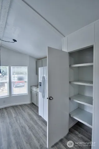 a view of empty room with a fireplace and window