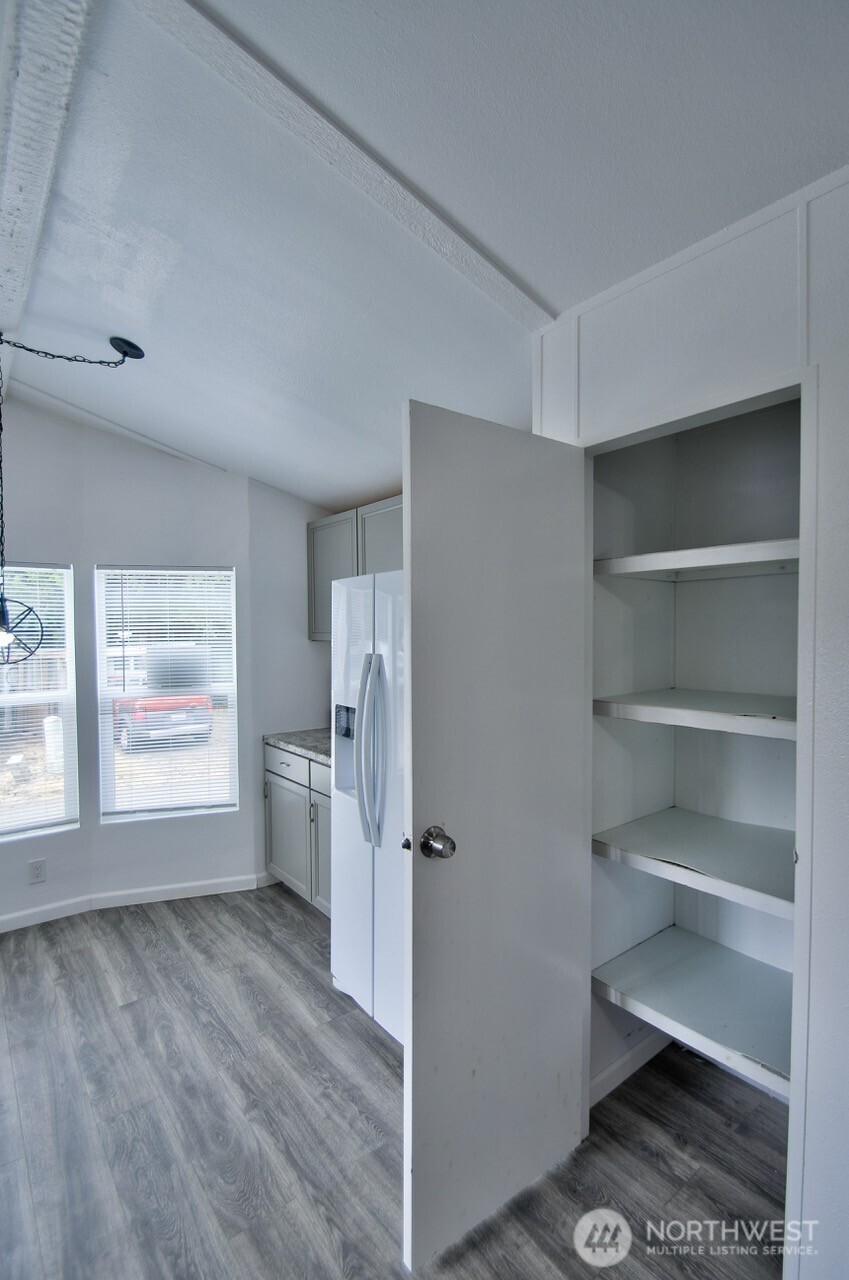 2115 Rocky Point Road Northwest, Unit 22 Bremerton, WA 98312 - Photo 7 of 16 a view of empty room with a fireplace and window