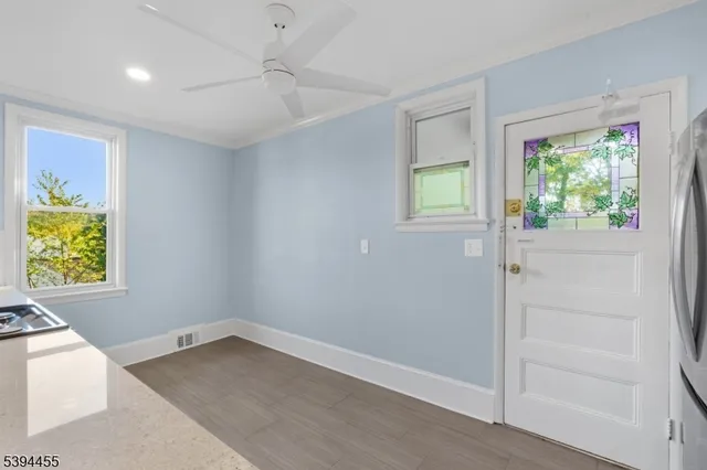 wooden floor in an empty room with a window
