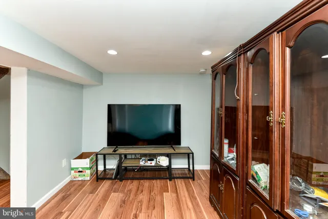 a bedroom with a bed and dresser with cabinet