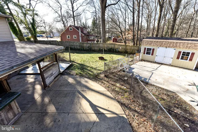 a front view of a house with a yard covered with snow