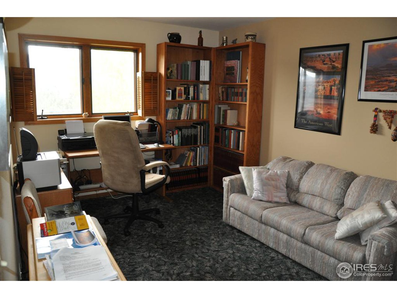 440 Venner Ranch Road Estes Park, CO 80517 - Photo 11 of 25 a living room with furniture a bookshelf and a large window