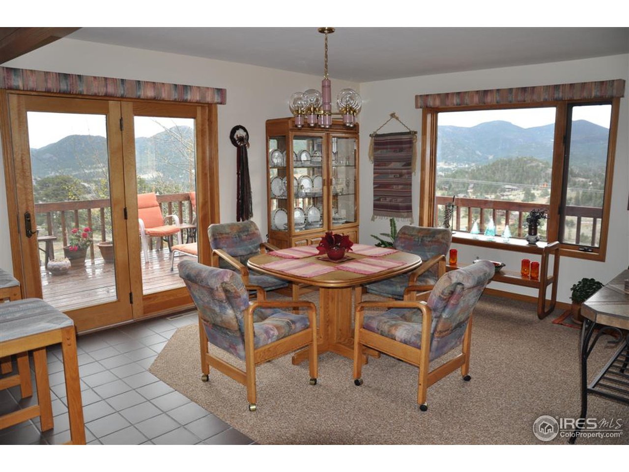 440 Venner Ranch Road Estes Park, CO 80517 - Photo 7 of 25 a dining room with furniture a chandelier and wooden floor