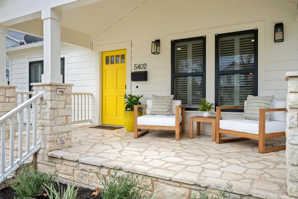 a view of a house with swimming pool and sitting area