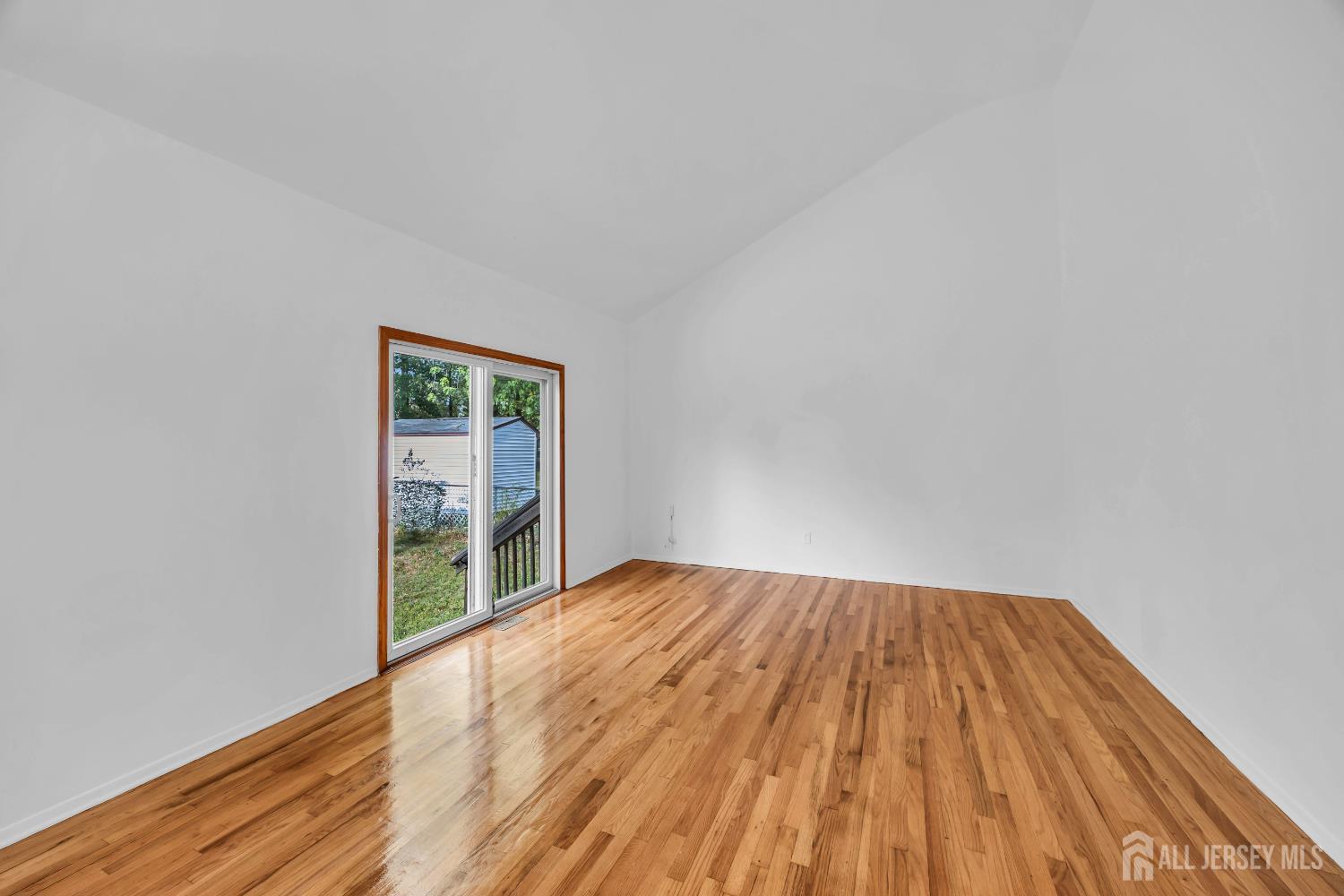 23 Barlow Road Edison, NJ 08817 - Photo 19 of 50 a view of an empty room with wooden floor and a window