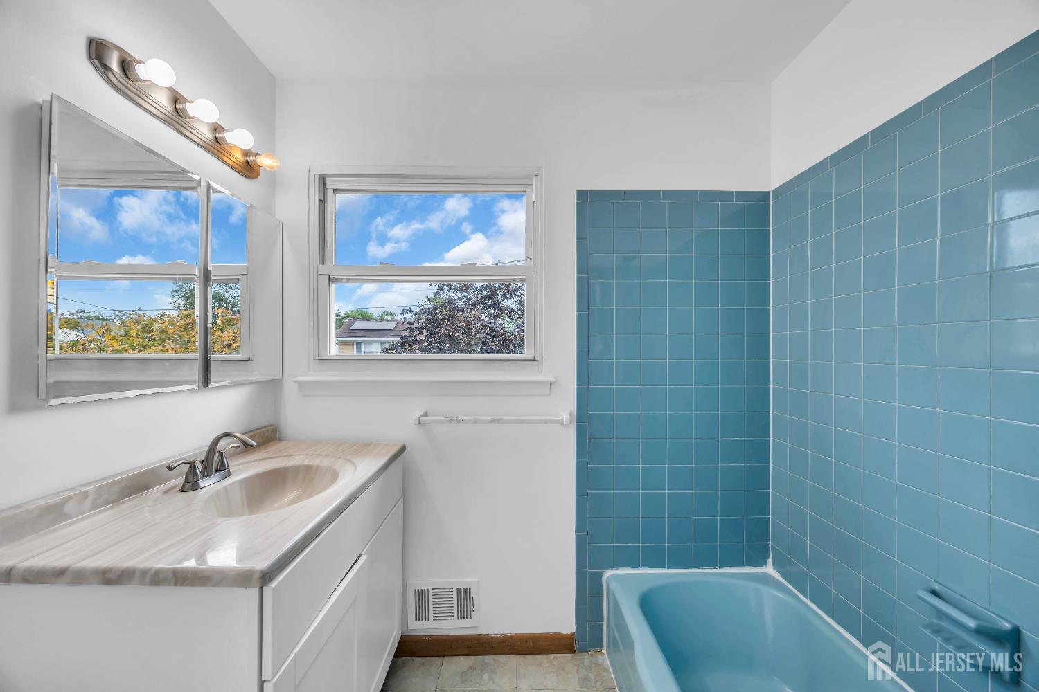 23 Barlow Road Edison, NJ 08817 - Photo 30 of 50 a bathroom with a granite countertop sink a large mirror a bathtub and shower