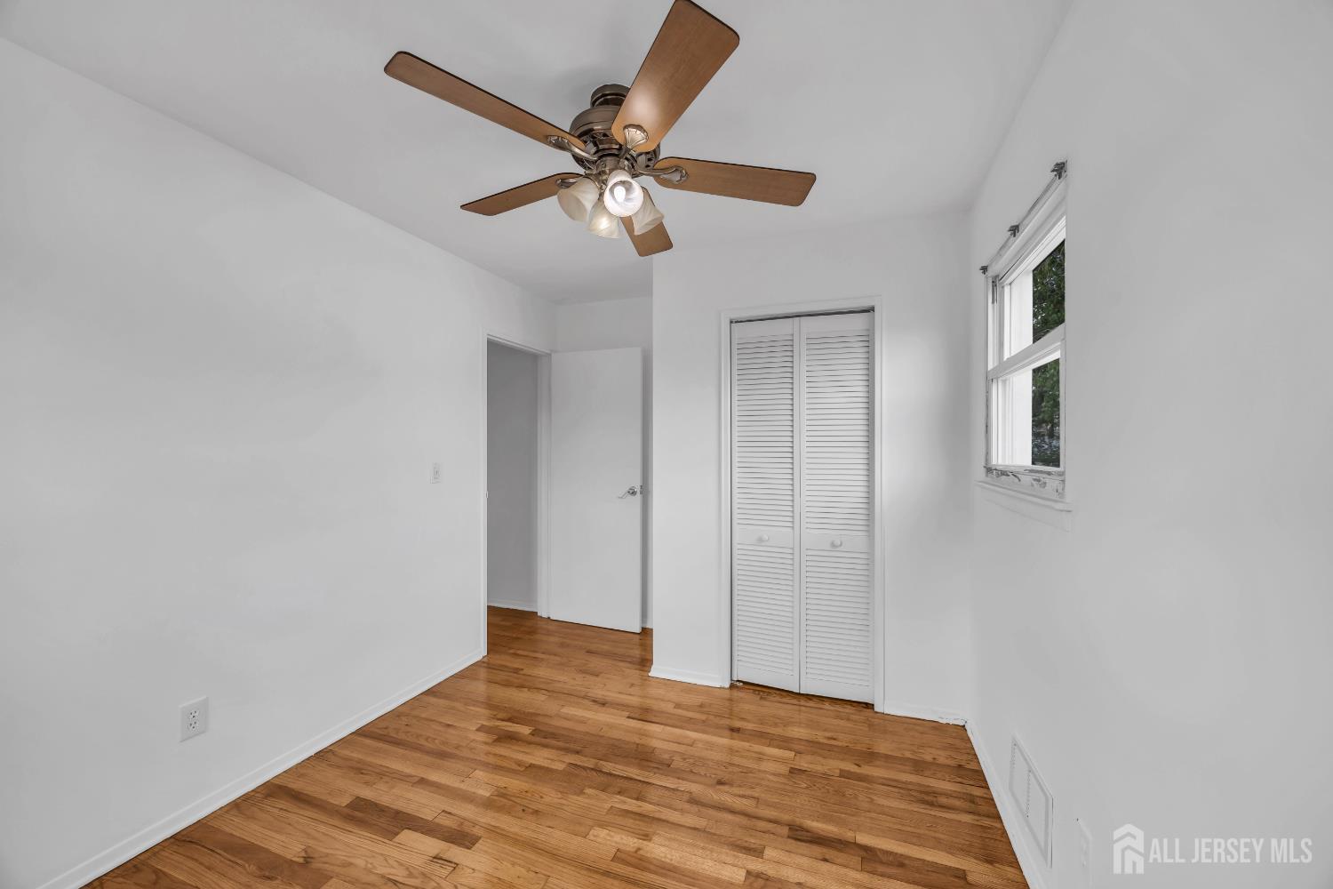 23 Barlow Road Edison, NJ 08817 - Photo 33 of 50 a view of a room with a ceiling fan and wooden floor