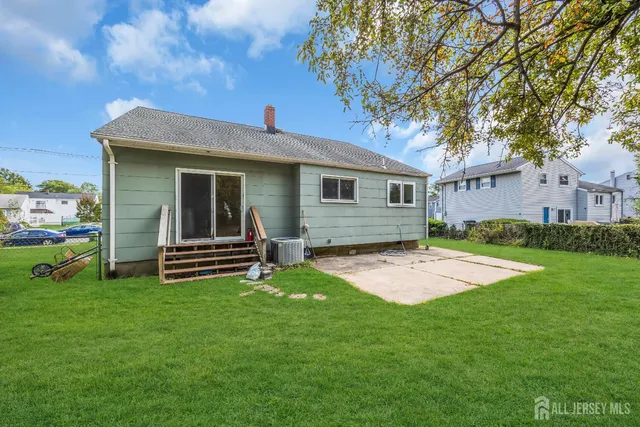 a view of a house with a yard and sitting area