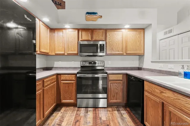 a kitchen with a sink stove and microwave