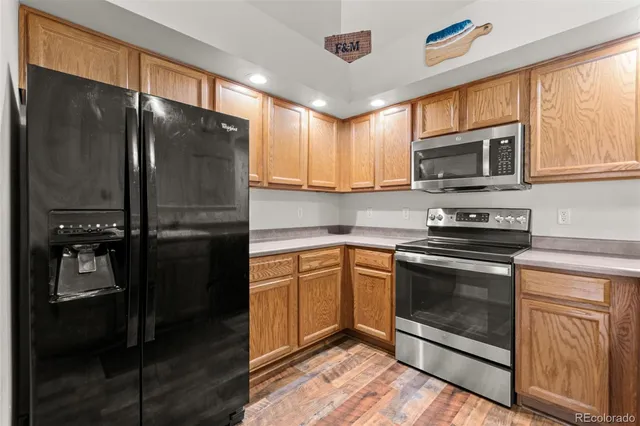 a kitchen with a refrigerator stove and microwave