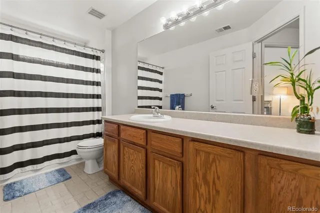 a bathroom with a sink a toilet and a window