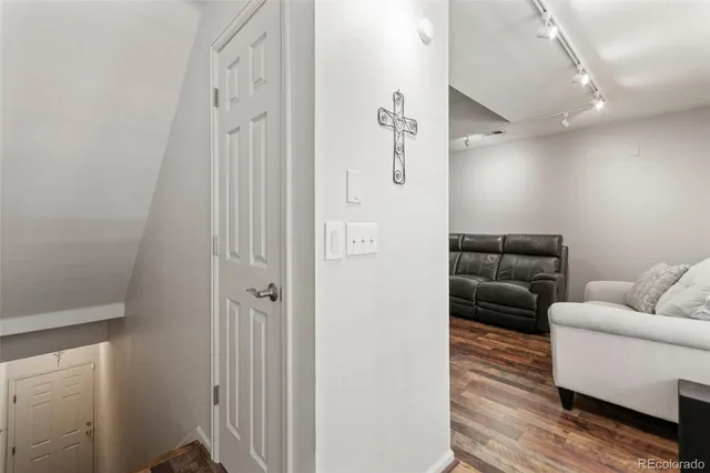 a living room with furniture and a ceiling fan