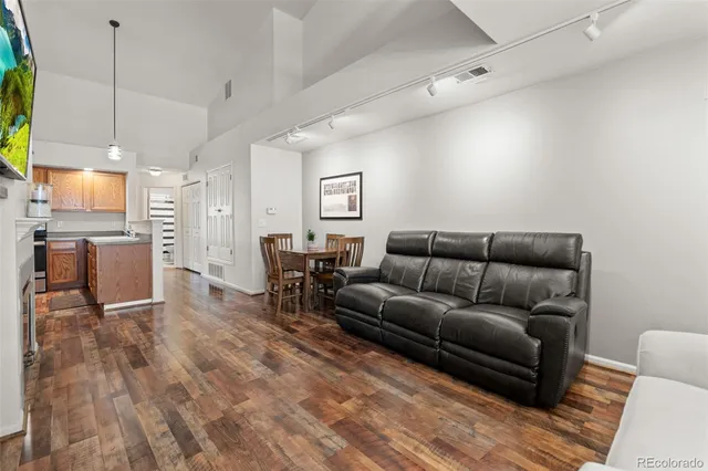 a living room with furniture and kitchen view