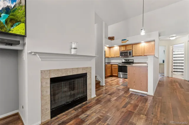 a view of kitchen with microwave stove refrigerator and cabinets