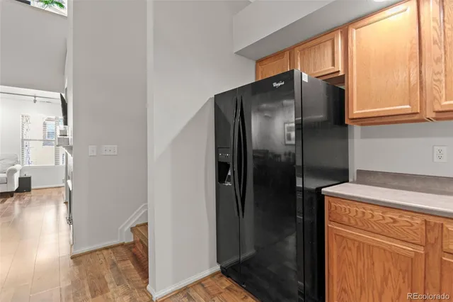 a metallic refrigerator freezer sitting inside of a kitchen