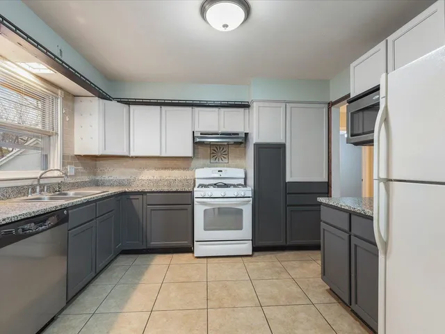 a kitchen with a sink cabinets and stainless steel appliances
