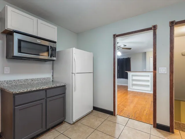 a kitchen with a refrigerator and microwave
