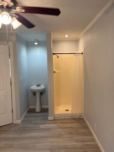 401 Reynolds Road Athens, TX 75751 - Photo 9 of 13 Pedestal sink and stand-up shower with wood-finish flooring in a bedroom