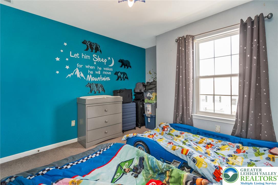 3566 Penfield Way Nazareth, PA 18064 - Photo 37 of 47 A well-lit bedroom provides ample natural light through a clear window, offering a comfortable personal space.